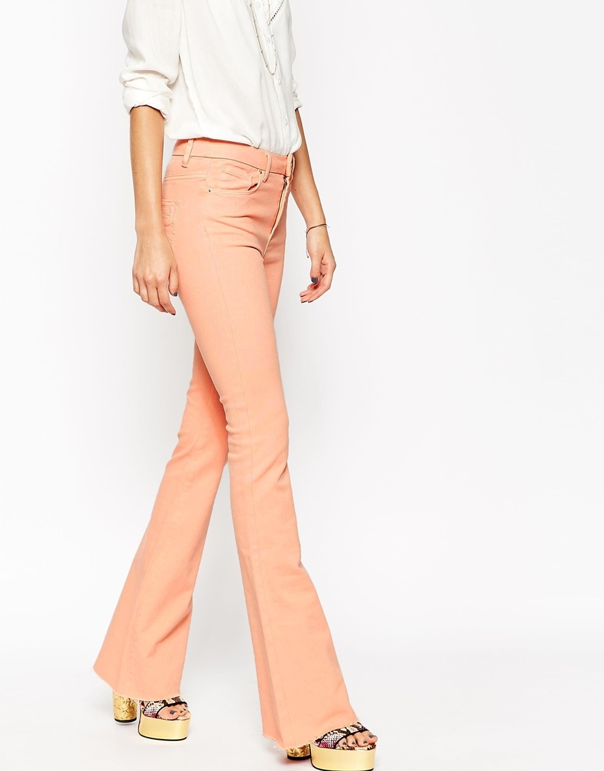 Bell Flare Jeans With Raw Hem Pink - style: flares; length: standard; pattern: plain; pocket detail: traditional 5 pocket; waist: mid/regular rise; predominant colour: blush; occasions: casual; fibres: cotton - stretch; texture group: denim; pattern type: fabric; trends: seventies retro; season: s/s 2015