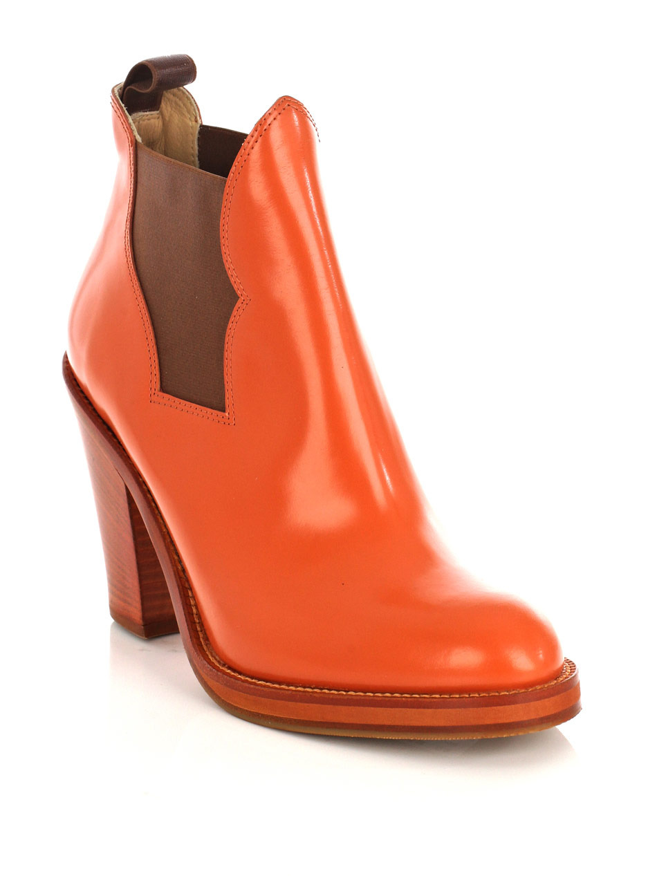 Star Ankle Boots - predominant colour: bright orange; material: leather; heel height: high; embellishment: elasticated; heel: block; toe: round toe; boot length: ankle boot; style: riding