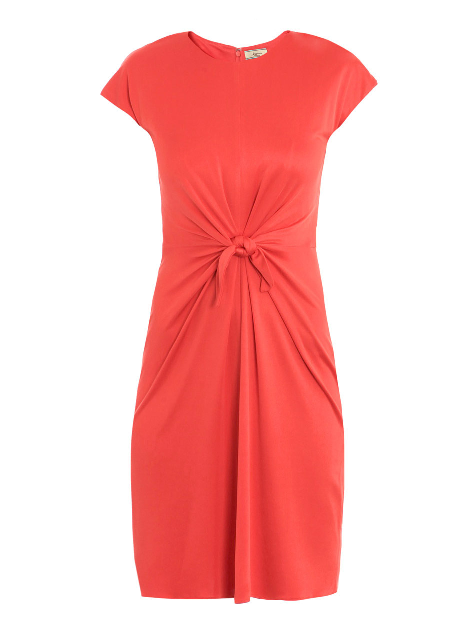 Knotted Front Dress - style: shift; neckline: round neck; sleeve style: capped; pattern: plain; waist detail: fitted waist, twist front waist detail/nipped in at waist on one side/soft pleats/draping/ruching/gathering waist detail, belted waist/belt detail/tie at waist; predominant colour: coral; occasions: casual wear, evening wear; length: just above the knee; fit: body skimming; material: pure silk; material texture: jersey; hip detail: soft pleats at hip/draping at hip; trends: pastels, brights; sleeve length: short sleeve