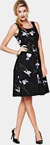 Oleander Sundress, Black - sleeve style: sleeveless; style: prom dress; waist detail: fitted waist; secondary colour: white; predominant colour: black; length: just above the knee; fit: fitted at waist & bust; fibres: cotton - stretch; occasions: occasion, holiday; hip detail: structured pleats at hip; sleeve length: sleeveless; texture group: cotton feel fabrics; neckline: low square neck; pattern type: fabric; pattern size: light/subtle; pattern: florals