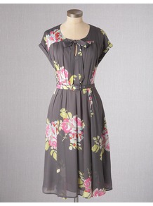 Bow Front Dress - style: tea dress; neckline: round neck; sleeve style: capped; fit: fitted at waist; bust detail: added detail/embellishment at bust; waist detail: belted waist/tie at waist/drawstring; predominant colour: charcoal; occasions: casual, evening, work, holiday; length: on the knee; fibres: viscose/rayon - 100%; hip detail: structured pleats at hip; sleeve length: short sleeve; texture group: sheer fabrics/chiffon/organza etc.; trends: high impact florals; pattern type: fabric; pattern size: big & busy; pattern: florals