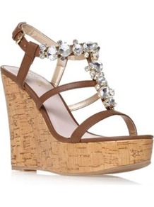 Marcie - predominant colour: tan; occasions: casual, evening, occasion, holiday; material: faux leather; heel height: high; embellishment: crystals; ankle detail: ankle strap; heel: wedge; toe: open toe/peeptoe; style: strappy; trends: metallics; finish: plain; pattern: plain