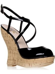 Maldiva - predominant colour: black; occasions: casual, evening, holiday; material: faux leather; heel height: high; embellishment: buckles; ankle detail: ankle strap; heel: wedge; toe: open toe/peeptoe; style: strappy; finish: patent; pattern: plain