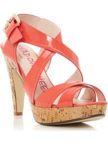 Coral Synthetic Patent Florence Cross Over Strap Heeled Sandal - predominant colour: coral; occasions: evening, holiday; material: faux leather; heel height: high; ankle detail: ankle strap; heel: platform; toe: open toe/peeptoe; style: strappy; finish: patent; pattern: plain