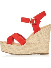 Whispered Cross Over Wedges - predominant colour: true red; occasions: casual, evening, work, holiday; material: leather; heel height: high; ankle detail: ankle strap; heel: wedge; toe: open toe/peeptoe; style: standard; finish: plain; pattern: plain