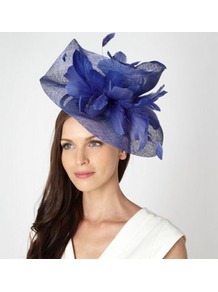 Designer Blue Twist Feather Head Piece - predominant colour: royal blue; occasions: evening, occasion; type of pattern: small; style: fascinator; size: large; material: macrame/raffia/straw; embellishment: feather; pattern: plain