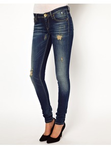 Distressed Skinny Jeans - style: skinny leg; length: standard; pattern: plain; waist: low rise; pocket detail: traditional 5 pocket; predominant colour: navy; occasions: casual; fibres: cotton - stretch; jeans detail: whiskering, washed/faded; texture group: denim; pattern type: fabric