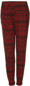 Bright Aztec Jersey Tapered Trousers - style: peg leg; waist: high rise; predominant colour: true red; secondary colour: black; occasions: casual, evening, holiday; length: ankle length; fibres: polyester/polyamide - stretch; trends: statement prints; fit: tapered; pattern type: fabric; pattern size: standard; pattern: patterned/print; texture group: jersey - stretchy/drapey