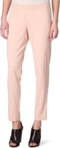 Katla Trousers - pattern: plain; waist detail: elasticated waist; pocket detail: small back pockets, pockets at the sides; waist: mid/regular rise; predominant colour: blush; occasions: casual, evening, work; length: ankle length; fibres: polyester/polyamide - stretch; hip detail: front pleats at hip level, fitted at hip (bottoms); texture group: crepes; trends: sporty redux; fit: slim leg; pattern type: fabric; style: standard