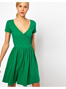 Skater Dress With Ballet Wrap And Short Sleeves. - style: faux wrap/wrap; neckline: low v-neck; pattern: plain; waist detail: twist front waist detail/nipped in at waist on one side/soft pleats/draping/ruching/gathering waist detail; predominant colour: emerald green; occasions: casual, evening; length: just above the knee; fit: fitted at waist & bust; fibres: cotton - stretch; hip detail: soft pleats at hip/draping at hip/flared at hip; sleeve length: short sleeve; sleeve style: standard; trends: volume; pattern type: fabric; texture group: jersey - stretchy/drapey