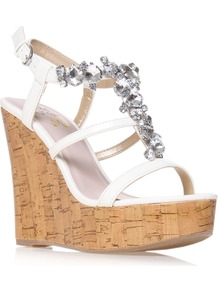 Marcie - predominant colour: white; occasions: evening, occasion, holiday; material: faux leather; heel height: high; embellishment: crystals; ankle detail: ankle strap; heel: wedge; toe: open toe/peeptoe; style: strappy; finish: plain; pattern: plain